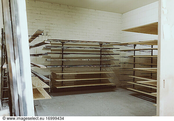 Planks in shelf at workshop