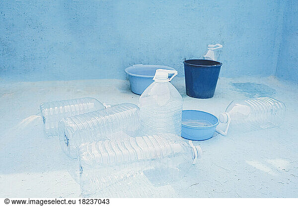 Plastic bottles and bucket in empty pool