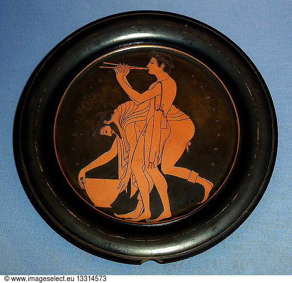 Plate designed by Epiktetos as painter. Epiktetos was a pupil of the first painters to use the red-figure technique  invented in Athens in about 530 BC. He decorated numerous cups and several plates. His clarity of line and the delicacy of the two revellers enable us to recognise even his unsigned work. Made in Athens about 520-500 BC