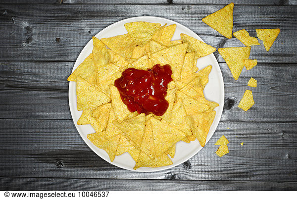 Plate of cheese nachos with salsa