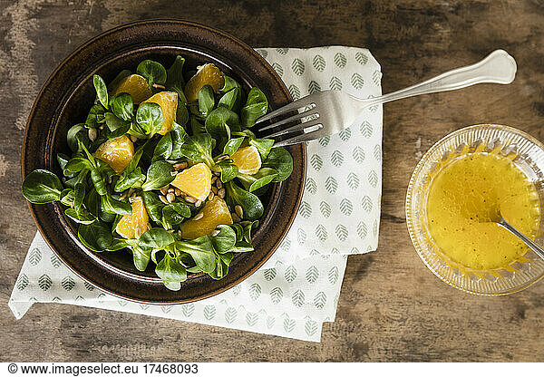 Plate of corn salad with pieces of orange