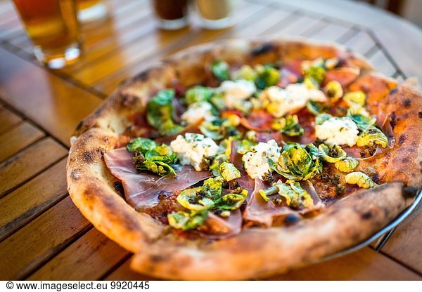 Plate of fresh pizza on restaurant table