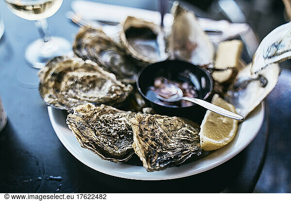Plate of oysters on table
