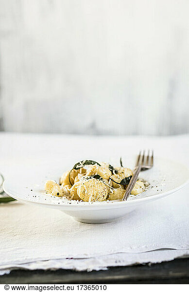 Plate of ready-to-eat Italian gnocchi dumplings with grated Parmesan cheese