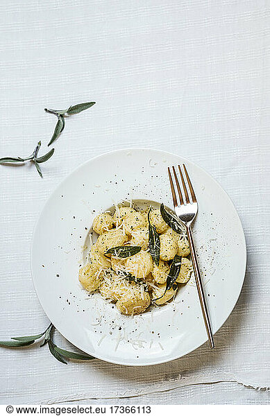 Plate of ready-to-eat Italian gnocchi dumplings with grated Parmesan cheese