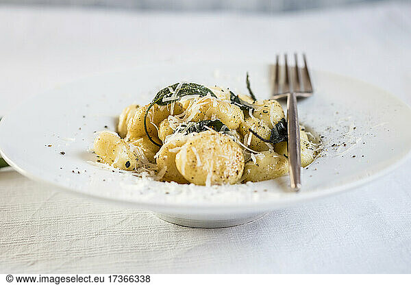 Plate of ready-to-eat Italian gnocchi dumplings with grated Parmesan cheese