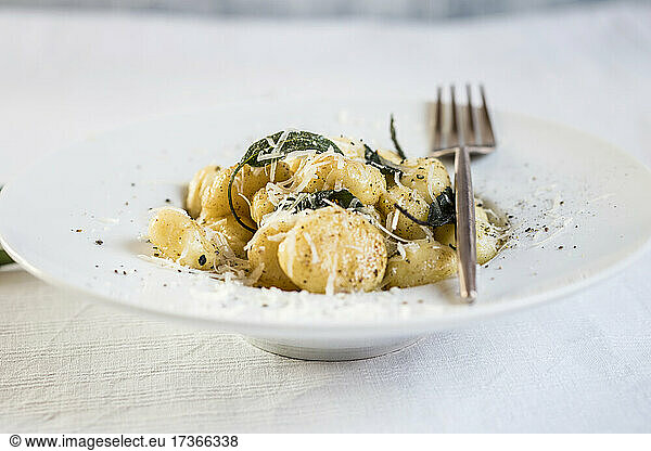 Plate of ready-to-eat Italian gnocchi dumplings with grated Parmesan cheese