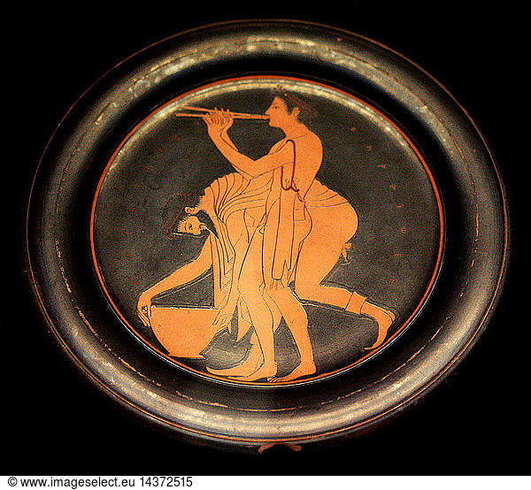 Plate signed by Epikleitos as painter. Epikleitos was a pupil of the first painters to use the red figure technique  invented in Athens in about 530 BC. He decorated numerous cups and several plates. His clarity of line and the deliecacy of the two revellers enable us to recognise even his unsigned works. Made in Athens about 520-500BC