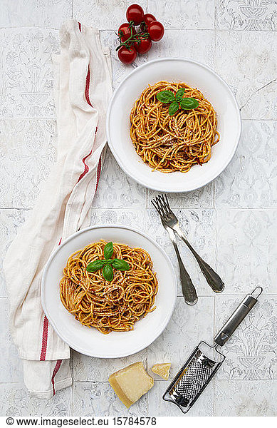 Plates of spaghetti with tomato sauce Parmesan cheese and basil