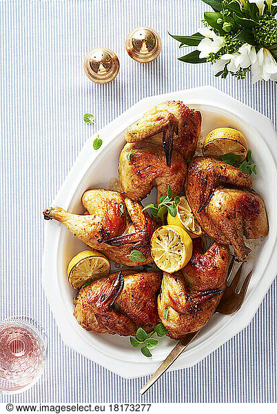 Platter of roasted cornish hens with lemon and herbs