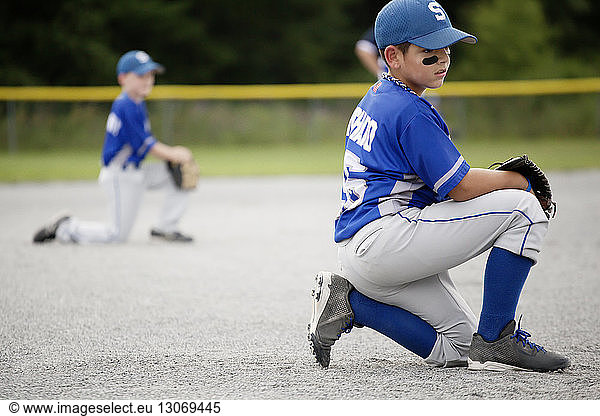 Player looking away while kneeling on field