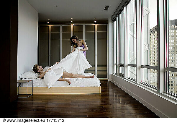 Playful Couple In Bedroom