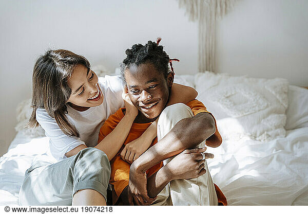 Playful couple spending leisure time on bed