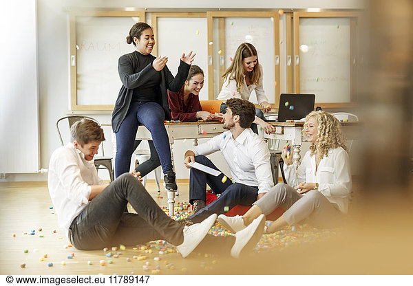 Playful creative professionals meeting in office