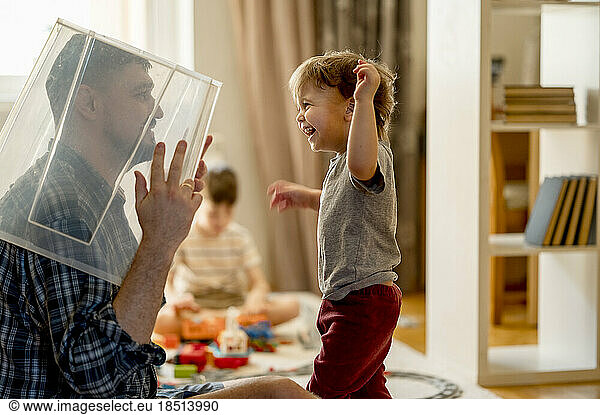 Playful father playing with son at home