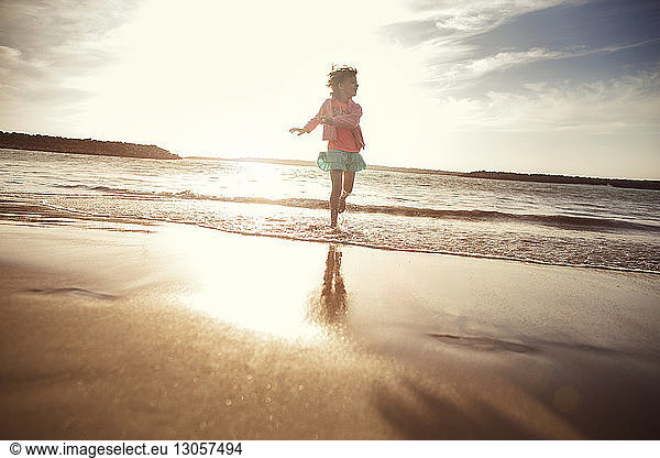Playful girl in water at beach