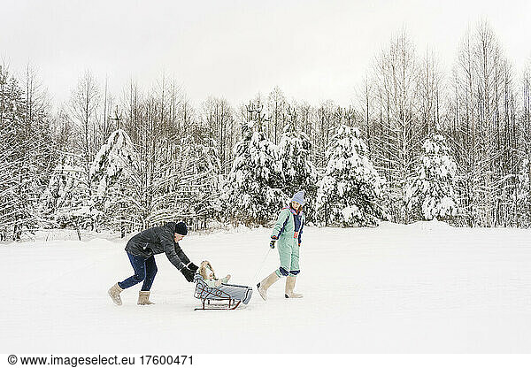Playful parents with daughter in winter