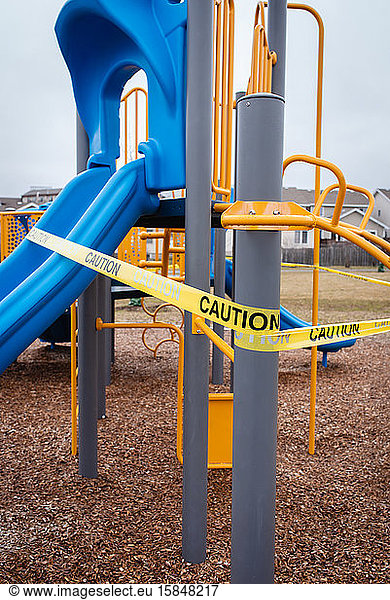 Playground equipment wrapped in caution tape during Covid 19 pandemic.
