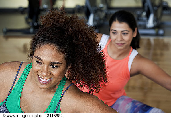 Plus size females exercising in gym