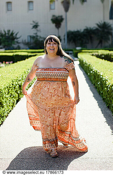 Plus Size Model Wearing Long Orange Dress in San Diego