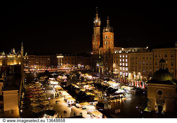 Poland  Krakow  main square  Constitution Day celebration at night with St. Mary's Basilica illuminated.