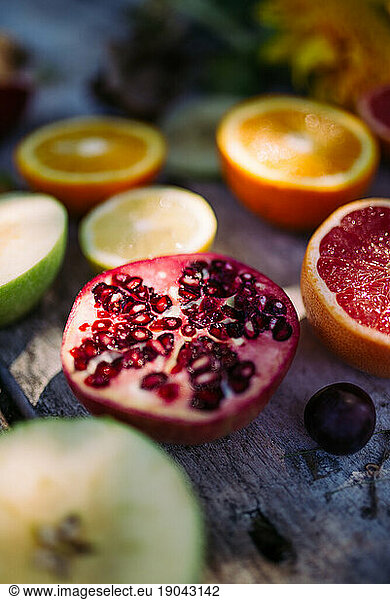 Pomegranate with fruit on the rustic table.