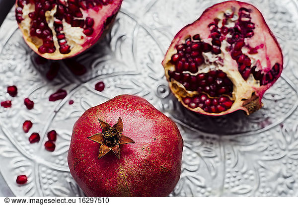 Pomegranates [Punica granatum] on silver tray