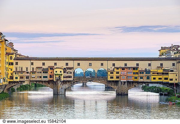 Ponte Vecchio on the Arno river and buildings in old town at sunrise  Florence (Firenze)  Tuscany  Italy