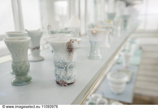 Porcelain vases on shelf in a glass house  Bavaria  Germany
