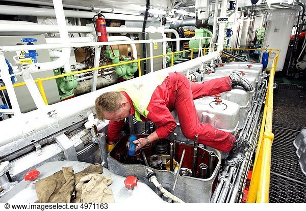 Port of Rotterdam  Rotterdam  Netherlands. Engineer maintaining the engine of his sea going vessel.