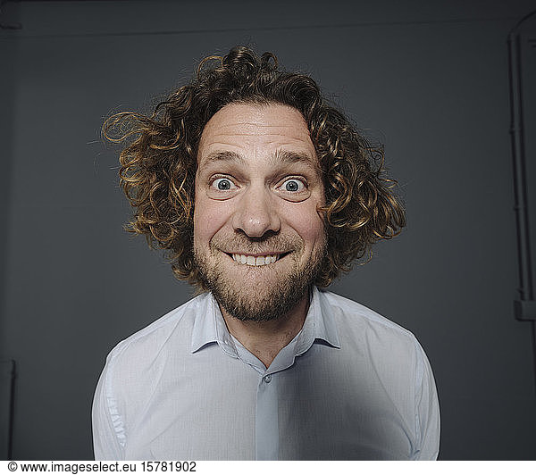 Portait of businessman pulling funny faces