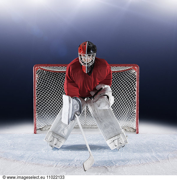Porträt ermittelter Hockeytorhüter schützt Tornetz auf Eis