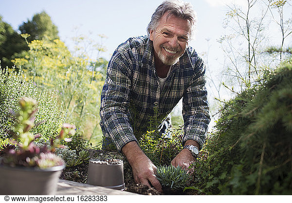 Porträt glücklicher älterer Mann beim Gärtnern