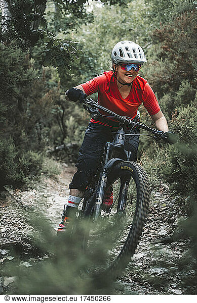 Portrait action shot of young female mountainbiker on Trail