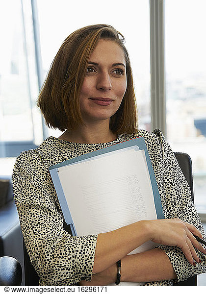 Portrait ambitious businesswoman with paperwork