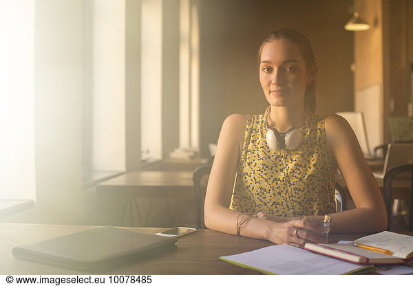 Portrait casual businesswoman with headphones working in office