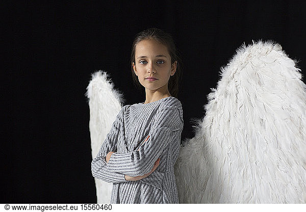 Portrait confident  brave girl wearing angel wings