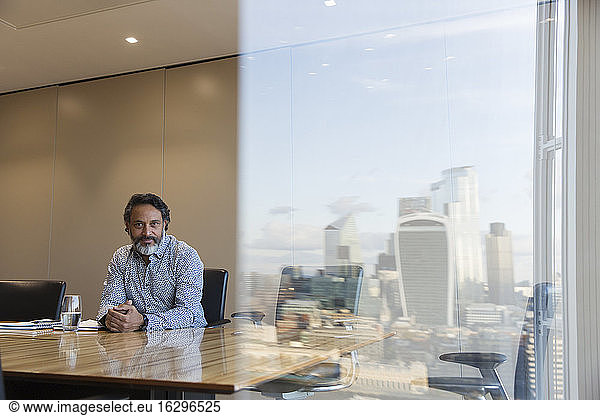 Portrait confident businessman in highrise conference room  London  UK