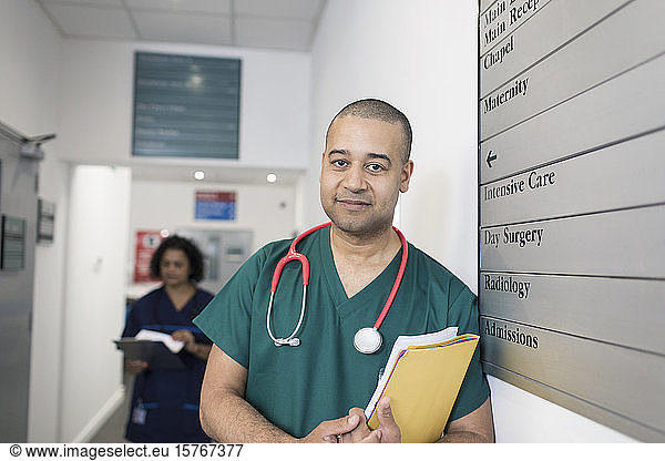 Portrait confident confident male surgeon in hospital corridor
