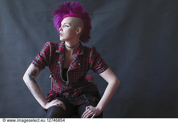 Portrait confident  cool young woman with pink mohawk
