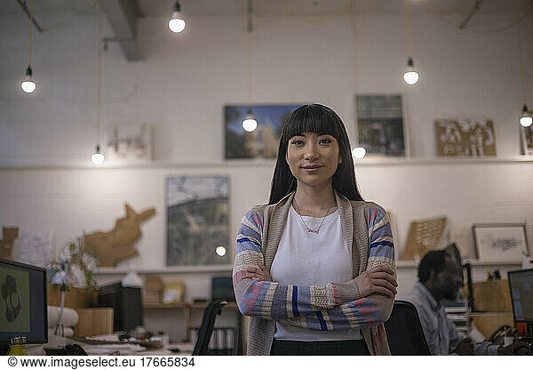 Portrait confident female designer standing in office