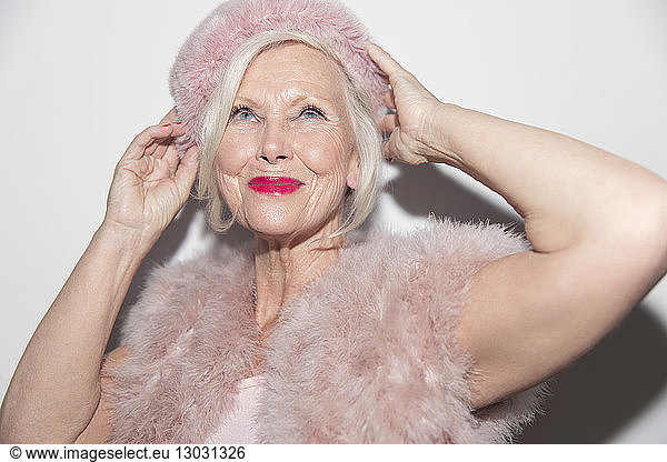 Portrait confident  glamorous senior woman wearing pink fur
