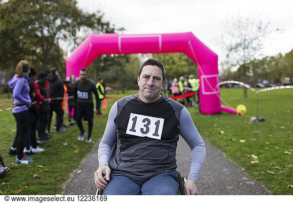 Portrait confident man in wheelchair at charity race