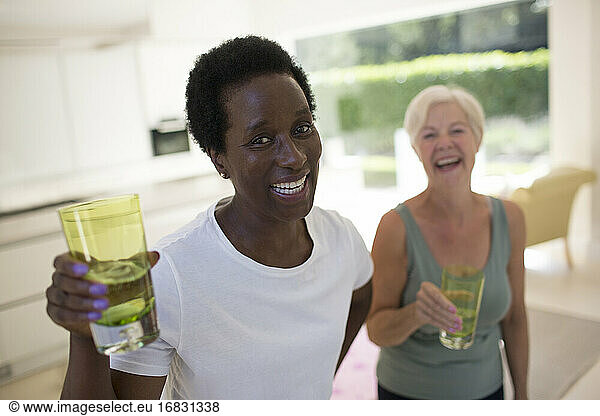 Portrait confident senior women friends drinking water after workout