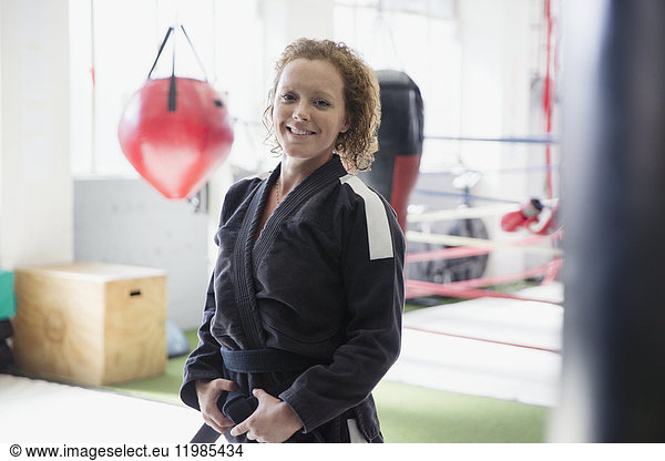 Portrait confident woman in judo uniform in gym