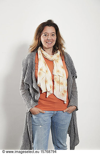 Portrait confident woman wearing scarf sweater and jeans