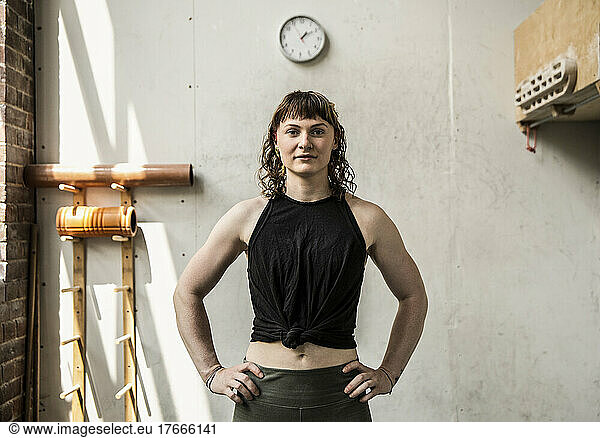 Portrait confident young woman exercising in gym
