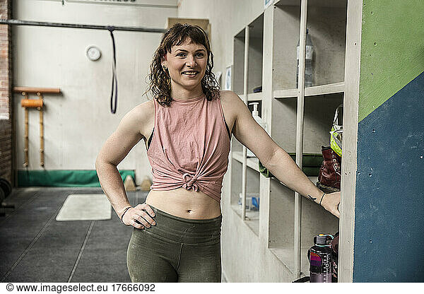Portrait confident young woman working out in gym
