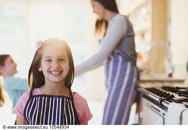 Portrait enthusiastic girl with toothy smile in kitchen