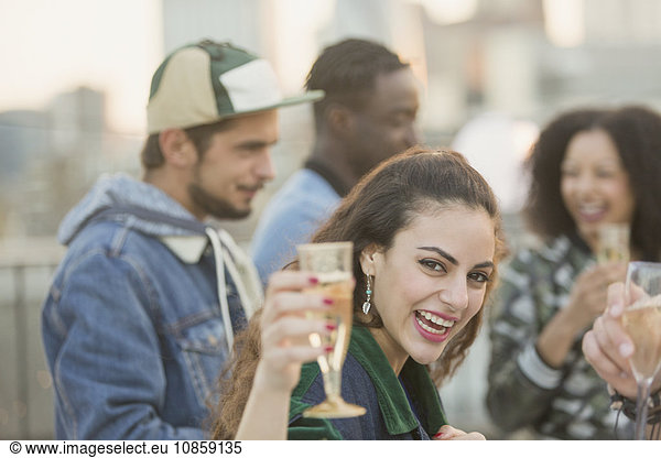 Portrait enthusiastic young woman drinking champagne at party